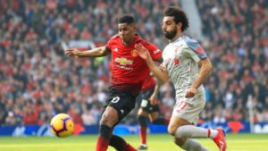 Liverpool's Mohamed Sala battle for the ball with United's Macus Rashford