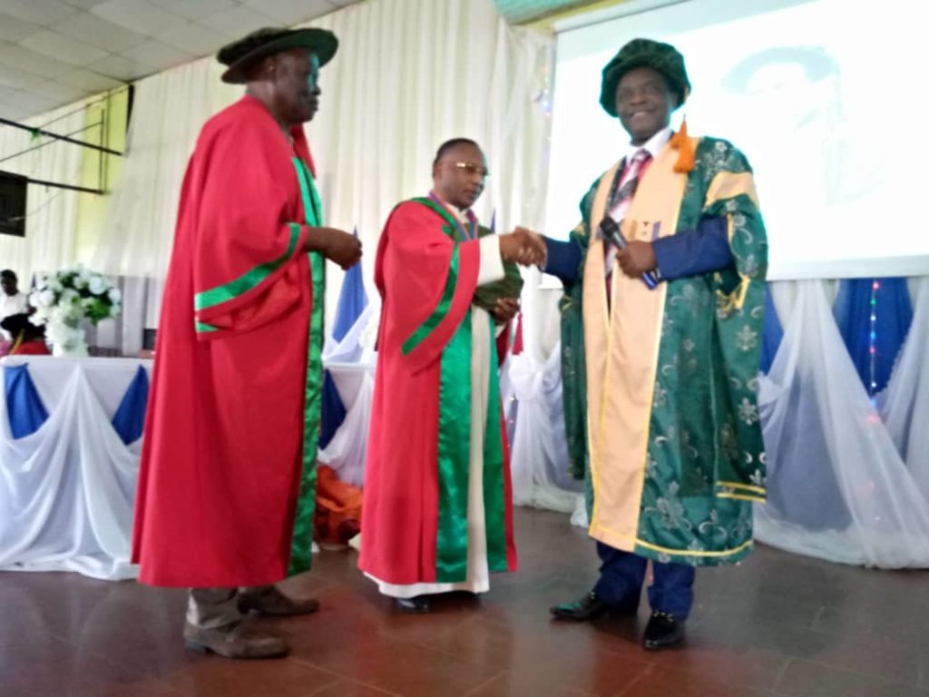 Rev. Prof. Bona Umeogu being decorated by Unizik Vice chancellor, Prof. Charles Esimone